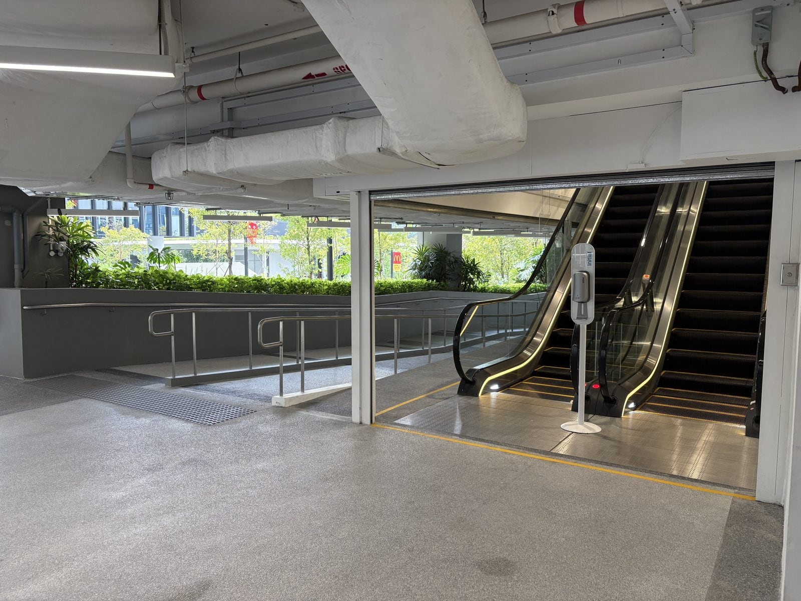The view from the map pin. Head for the amber-lit escalator on the right.