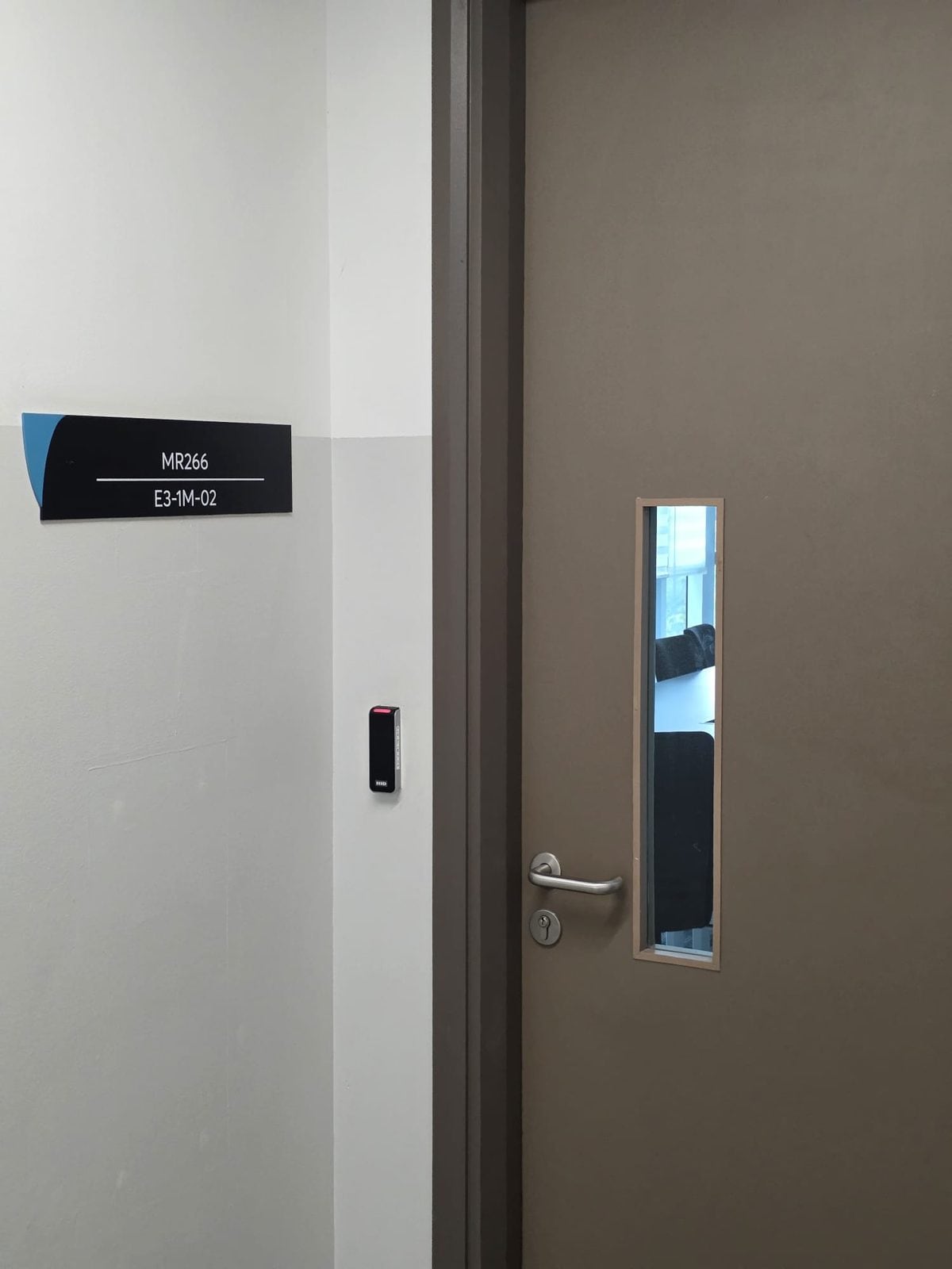 Sign on the wall, card reader, then the door.