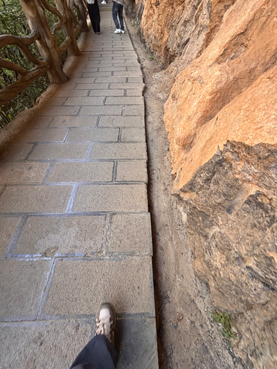 A stone path along a cliff, walked one step at a time